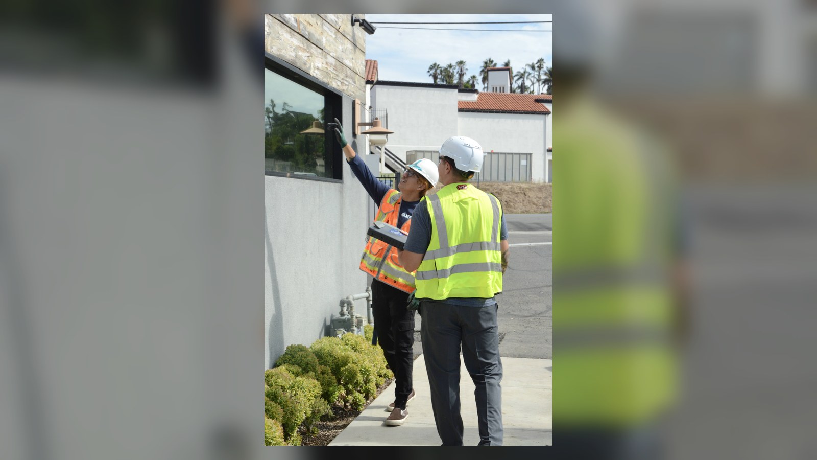 XRF Research field team reviewing an exterior wall during a lead inspection