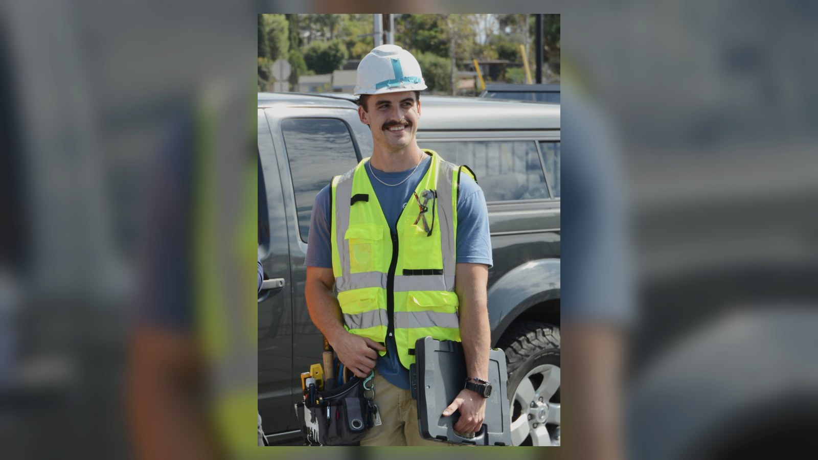XRF Research field team member wearing a hardhat and safety vest